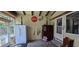 Enclosed sunroom with vintage decor, access door, and lots of natural light at 27751 Luella Ave, Paisley, FL 32767