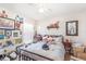 Bedroom featuring wood-look floors, a ceiling fan, a metal bed frame and posters at 2884 Sweet Springs St, Deltona, FL 32738