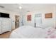 Primary bedroom featuring neutral walls, white trim, a ceiling fan and wood-look flooring at 2884 Sweet Springs St, Deltona, FL 32738
