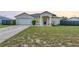 Charming single-Gathering home featuring a well-manicured lawn, inviting entry, and attached two-car garage at 2884 Sweet Springs St, Deltona, FL 32738