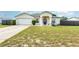 Charming single-Gathering home featuring a well-manicured lawn, inviting entry, and attached two-car garage at 2884 Sweet Springs St, Deltona, FL 32738