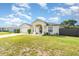 Inviting single-Gathering home with a well-kept lawn, attached garage, and charming front entrance, bathed in sunlight at 2884 Sweet Springs St, Deltona, FL 32738