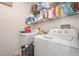 A functional laundry room equipped with a washer, dryer, and shelving for efficient organization at 2884 Sweet Springs St, Deltona, FL 32738