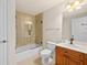 Bathroom with tiled shower and bathtub, toilet, and a wood vanity at 2901 S Atlantic Ave # 401, Daytona Beach Shores, FL 32118