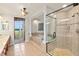Luxurious bathroom featuring a walk-in shower, soaking tub, and access to an outdoor balcony at 2901 S Atlantic Ave # 401, Daytona Beach Shores, FL 32118
