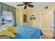 Inviting bedroom with ocean view, ceiling fan, and light yellow walls at 2901 S Atlantic Ave # 401, Daytona Beach Shores, FL 32118