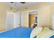 Bedroom with blue bedspread and a view into the bathroom at 2901 S Atlantic Ave # 401, Daytona Beach Shores, FL 32118
