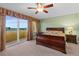 Cozy bedroom with ceiling fan, balcony access, and warm-toned decor at 2901 S Atlantic Ave # 401, Daytona Beach Shores, FL 32118