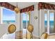 Dining area featuring a glass table and chairs offering stunning ocean views through large windows at 2901 S Atlantic Ave # 401, Daytona Beach Shores, FL 32118