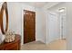 Entrance to condo with dark wood door and sidelights, interior view at 2901 S Atlantic Ave # 401, Daytona Beach Shores, FL 32118