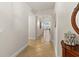 Hallway with decorative wall art, tiled floor, and view to the living room at 2901 S Atlantic Ave # 401, Daytona Beach Shores, FL 32118