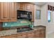 Updated kitchen features a granite countertop, glass backsplash and ocean view at 2901 S Atlantic Ave # 401, Daytona Beach Shores, FL 32118