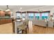 Modern kitchen and living room featuring an island bar, granite counters and ocean views at 2901 S Atlantic Ave # 401, Daytona Beach Shores, FL 32118