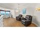 Inviting living room with two brown leather armchairs, stylish lighting, and an ocean view at 2901 S Atlantic Ave # 401, Daytona Beach Shores, FL 32118