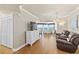 A living room showcasing a TV, hardwood floors, leather chairs and views of the ocean and dining area at 2901 S Atlantic Ave # 401, Daytona Beach Shores, FL 32118