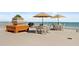 Outdoor patio features dining table with umbrella, grill, planter, and beach and ocean views at 2901 S Atlantic Ave # 401, Daytona Beach Shores, FL 32118