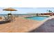 Swimming pool on a sunny day with patio furniture and ocean view at 2901 S Atlantic Ave # 401, Daytona Beach Shores, FL 32118