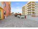 Condo rooftop patio with beautiful brick flooring, seating arrangements, and views of building at 2901 S Atlantic Ave # 401, Daytona Beach Shores, FL 32118