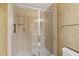 Modern shower with glass door, tiled walls, and chrome fixtures at 2901 S Atlantic Ave # 401, Daytona Beach Shores, FL 32118