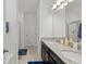 Bathroom featuring double sinks, granite counters, and a separate shower and toilet room at 2916 Meleto Blvd, New Smyrna Beach, FL 32168