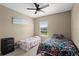 Cozy bedroom featuring two twin beds with colorful floral bedding at 2916 Meleto Blvd, New Smyrna Beach, FL 32168