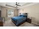 Bedroom with a ceiling fan, and a bed featuring a blue patterned comforter set at 2916 Meleto Blvd, New Smyrna Beach, FL 32168