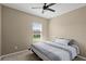 Comfortable bedroom with neutral tones, a ceiling fan, and a window at 2916 Meleto Blvd, New Smyrna Beach, FL 32168