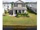 Charming two-story home with a welcoming front porch and well-manicured lawn near the water at 2916 Meleto Blvd, New Smyrna Beach, FL 32168