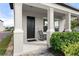 Inviting front porch with rocking chairs, offering a relaxing outdoor space and neighborhood views at 2916 Meleto Blvd, New Smyrna Beach, FL 32168