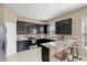 Modern kitchen featuring granite countertops, stainless steel appliances, and a breakfast bar with seating at 2916 Meleto Blvd, New Smyrna Beach, FL 32168