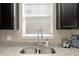 A stainless double bowl kitchen sink with chrome faucet below a bright window at 2916 Meleto Blvd, New Smyrna Beach, FL 32168