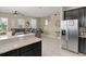 Open living space with a gray sofa, ceiling fan, and granite counters in view at 2916 Meleto Blvd, New Smyrna Beach, FL 32168