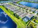 Aerial view highlighting a lakeside community with homes boasting pools and manicured lawns at 2919 Sime St, New Smyrna Beach, FL 32168
