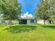 Spacious backyard featuring lush lawn and a charming screened patio, perfect for relaxing outdoors at 2919 Sime St, New Smyrna Beach, FL 32168