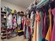 Walk-in closet with racks filled with clothes and handbags, and shelving with baskets for shoes and storage at 2919 Sime St, New Smyrna Beach, FL 32168