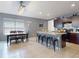 Modern kitchen with dark cabinets, stainless steel appliances, a large island with seating, and an adjacent dining area at 2919 Sime St, New Smyrna Beach, FL 32168