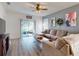 Inviting living room with a comfortable sectional sofa, wood-look flooring, and sliding glass doors leading to an outdoor patio at 2919 Sime St, New Smyrna Beach, FL 32168