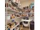 Walk-in pantry with ample shelving, filled with various food items and household supplies for convenient storage and organization at 2919 Sime St, New Smyrna Beach, FL 32168