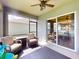 Inviting screened patio with ceiling fan and comfortable seating, perfect for relaxing outdoors at 2919 Sime St, New Smyrna Beach, FL 32168