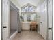 Bathroom featuring a walk in shower, large window, vanity area with chair and ample storage at 2980 Lockwood Blvd, Deltona, FL 32738