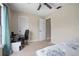 Bedroom with neutral carpet, a desk, and a bed with patterned linens at 2980 Lockwood Blvd, Deltona, FL 32738