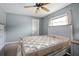 Bedroom featuring a ceiling fan, a large window, and light colored furniture at 2980 Lockwood Blvd, Deltona, FL 32738