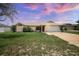 Inviting single-story home featuring a well-maintained lawn and an attached two-car garage at 2980 Lockwood Blvd, Deltona, FL 32738