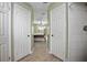 Hallway featuring tile floors, doorways to the main bedroom and bathroom and view of the main bedroom at 2980 Lockwood Blvd, Deltona, FL 32738