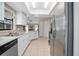 Well-lit kitchen with stainless steel appliances, white cabinets, and light countertops at 2980 Lockwood Blvd, Deltona, FL 32738