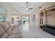 Open living room floorplan showing tiled floors and a slider leading to a screened-in pool at 2980 Lockwood Blvd, Deltona, FL 32738