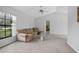 Spacious living room with vaulted ceilings, carpet flooring, and a large window offering natural light at 2980 Lockwood Blvd, Deltona, FL 32738