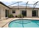 A screened-in pool features stylish tile detail and multiple steps for easy access at 2980 Lockwood Blvd, Deltona, FL 32738