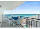 Breathtaking ocean and pool views from this comfortable condo balcony complete with seating and serving area at 2987 S Atlantic # 1403, Daytona Beach Shores, FL 32118