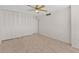 Well-lit bedroom with carpet, ceiling fan, and closet featuring white shutter doors at 2987 S Atlantic # 1403, Daytona Beach Shores, FL 32118